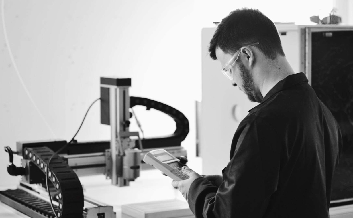 iGii engineer operating a precision printing gantry in the laboratory